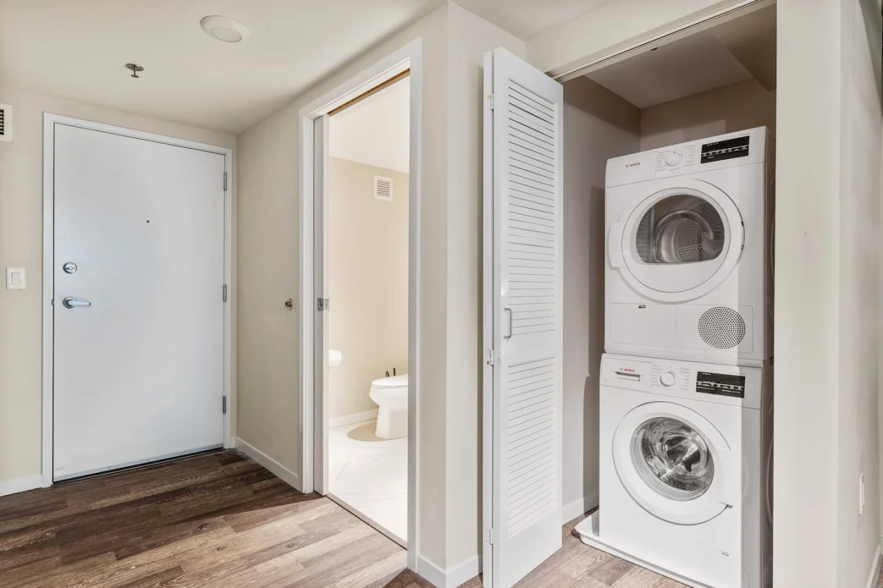 Laundry room with a washer, dryer, and folding area, offering all the convenience you need for a comfortable extended stay.