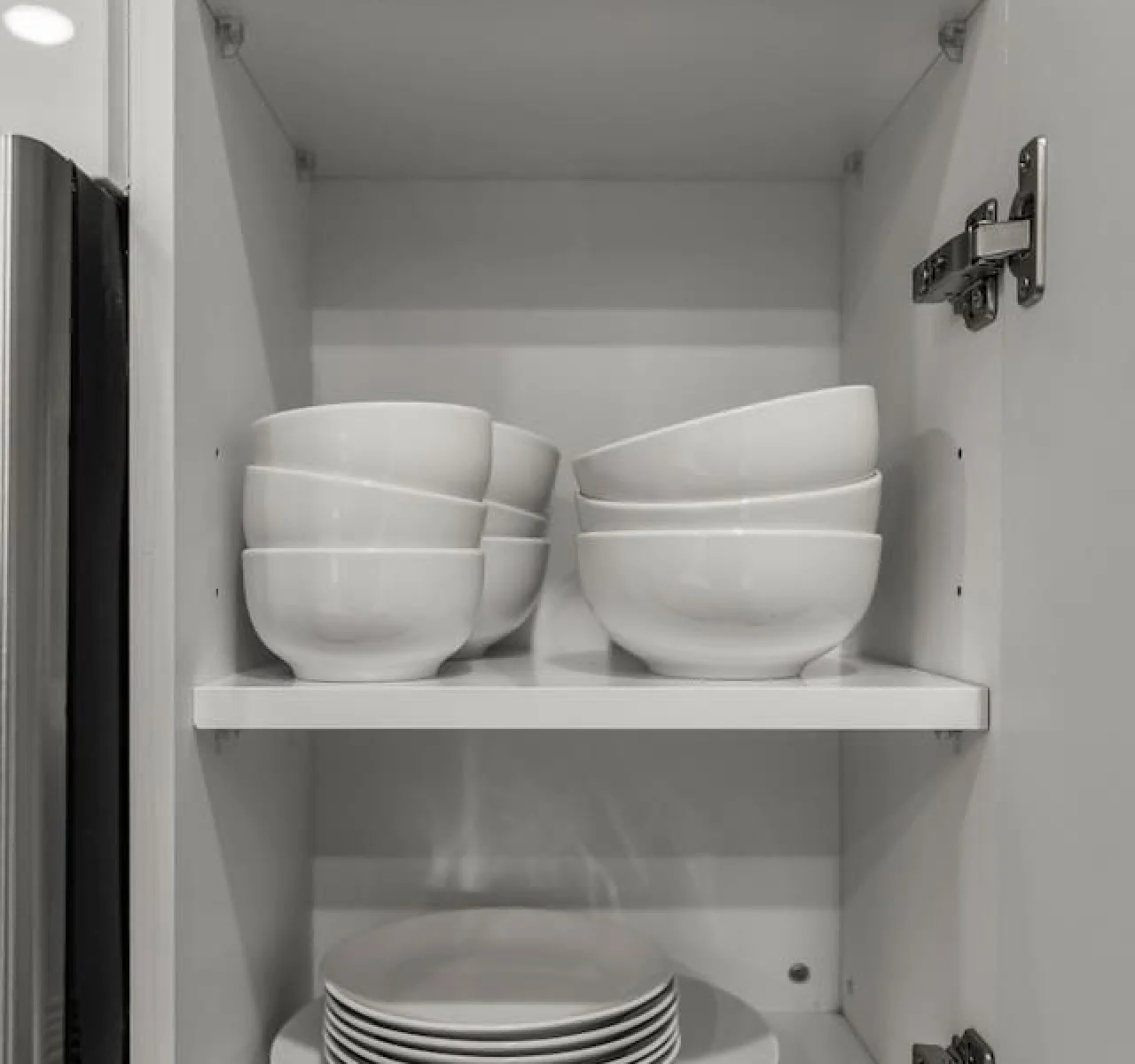 Kitchen cabinets stocked with cooking wares, glassware and silverwares, ideal for mixing up your favorite meals and drinks during your stay.