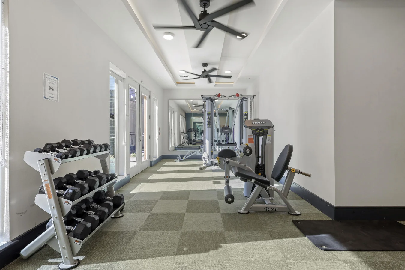 Dedicated space featuring a wide range of dumbbells, benches, and mirrors for strength and resistance training