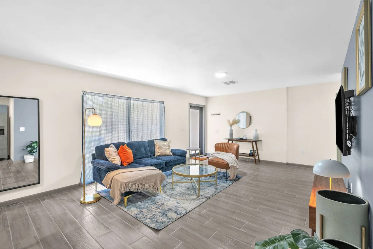 Bright and airy living room with plush seating, a large TV, and tasteful decor, creating the perfect space for relaxation and entertainment.