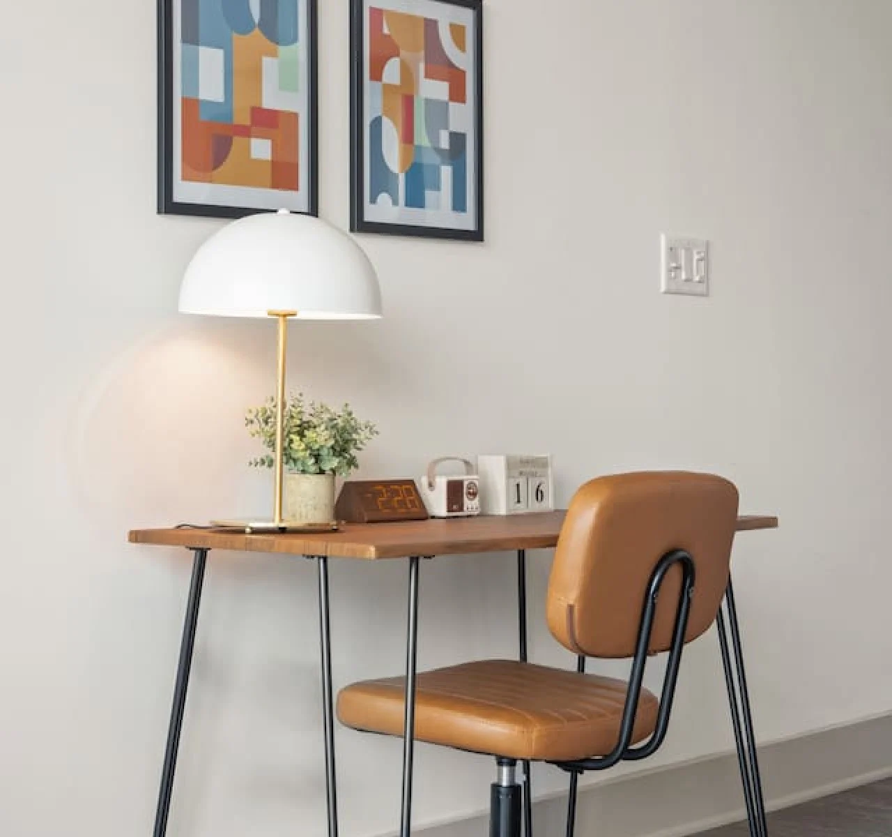 This cozy workspace with warm lighting, and a creative wall display, perfect for productivity.
