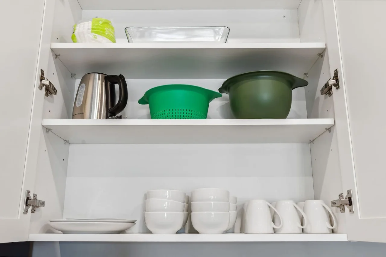 Kitchen cabinets stocked with cooking wares, glassware and silverwares, ideal for mixing up your favorite meals and drinks during your stay.