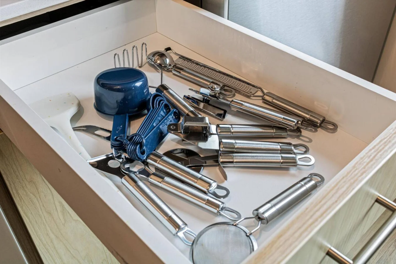 Kitchen utensils with scissors, measuring cups, grater, wine opener, can opener