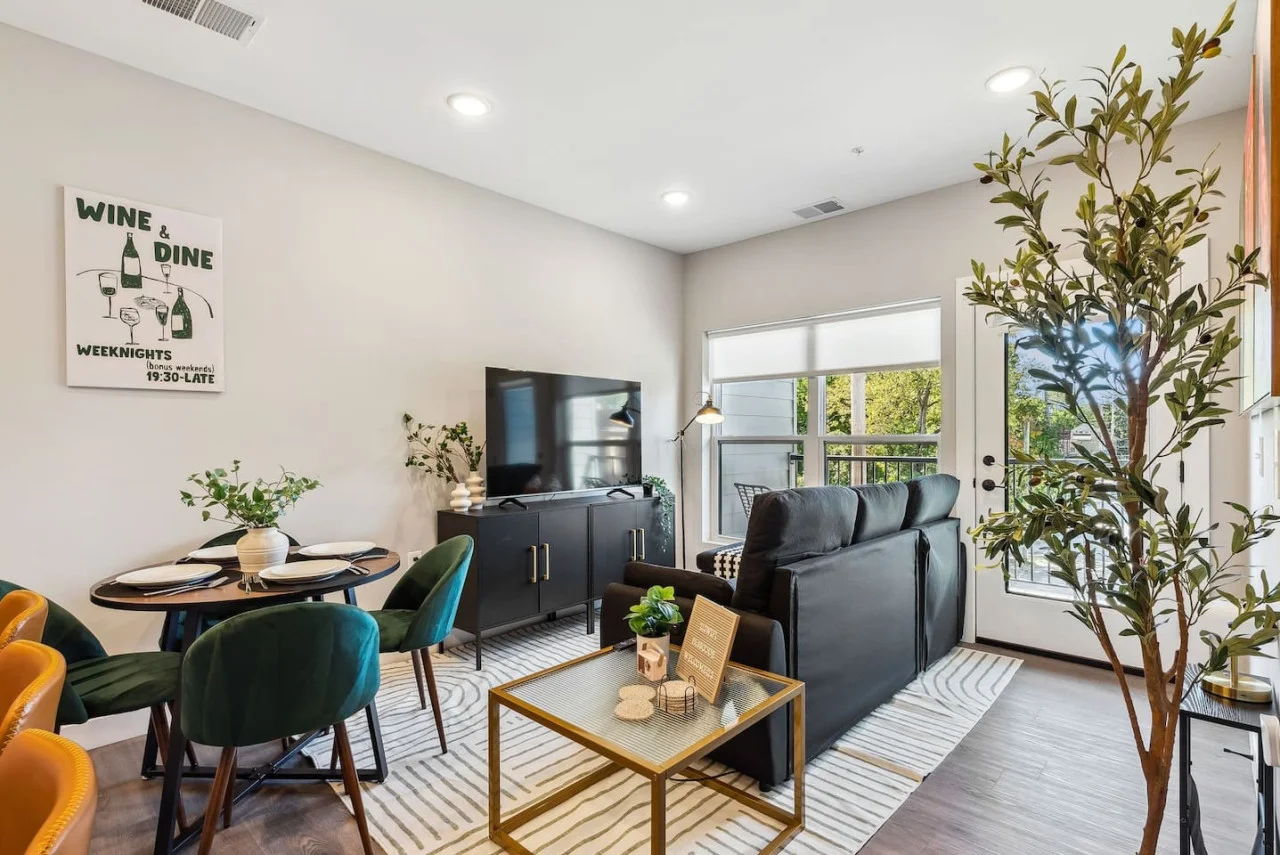 Bright and airy living room with plush seating, a large TV, and tasteful decor, creating the perfect space for relaxation and entertainment.
