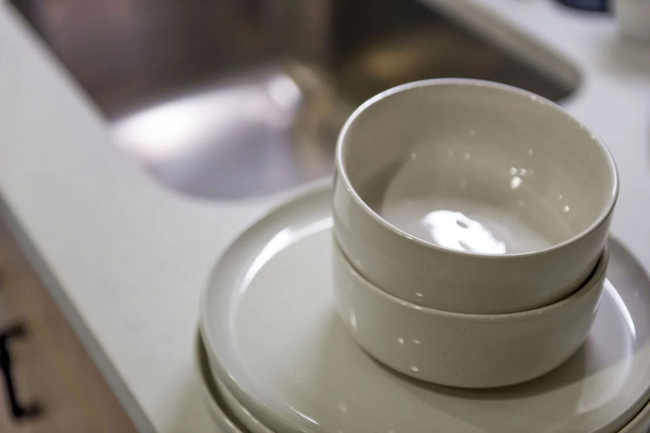 Kitchen cabinets stocked with cooking wares, glassware and silverwares, ideal for mixing up your favorite meals and drinks during your stay.