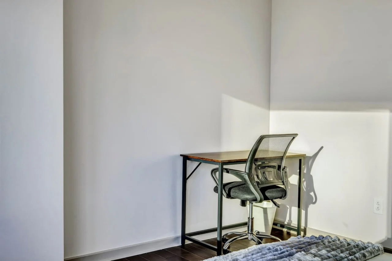 This cozy workspace with warm lighting, and a creative wall display, perfect for productivity.