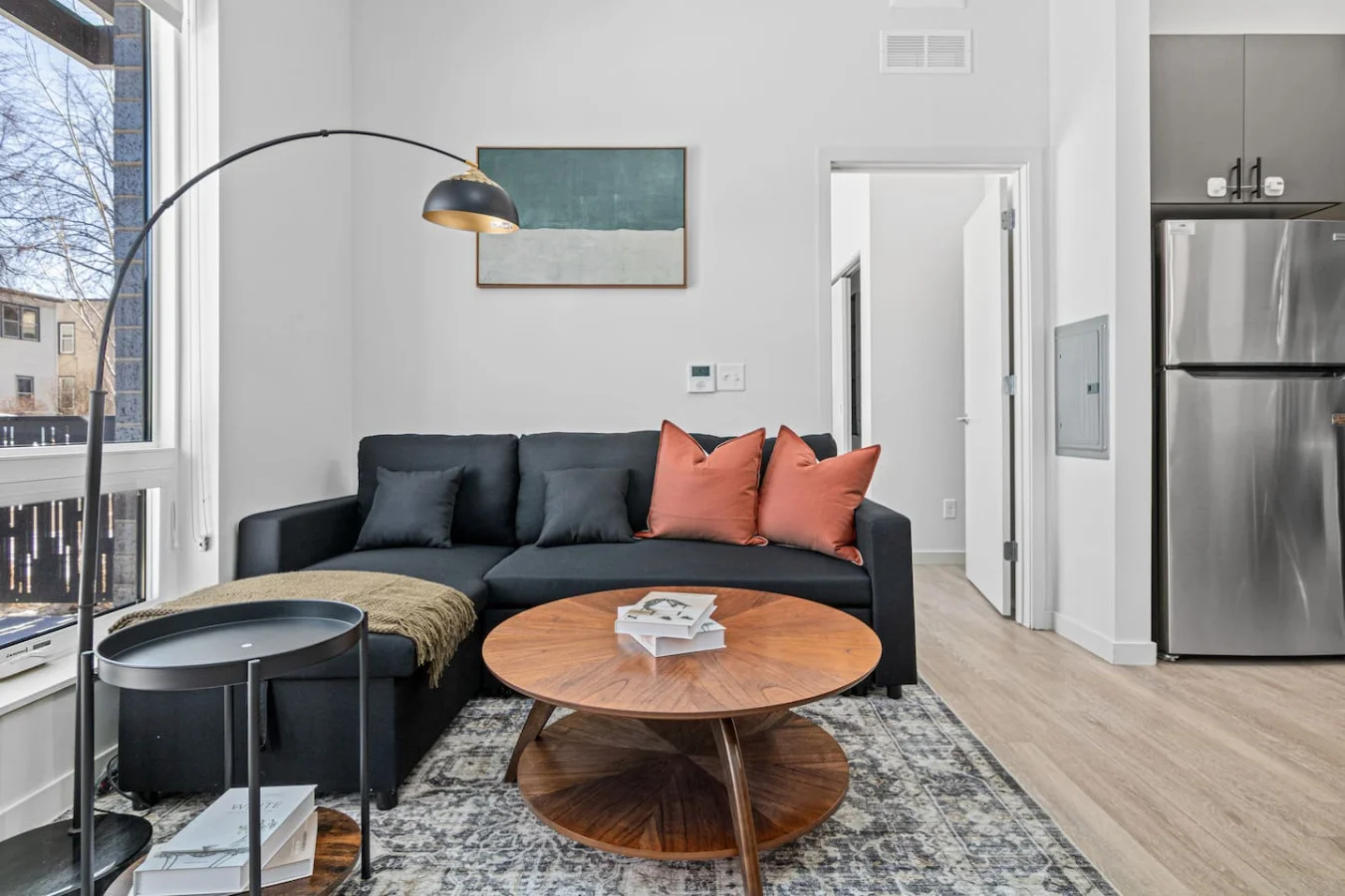 The living room’s cozy vibe makes it the perfect spot to relax, with ample seating and a warm ambiance.
