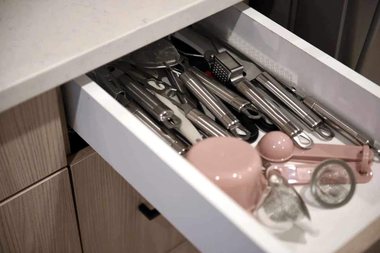 Kitchen cabinets stocked with cooking wares, glassware and silverwares, ideal for mixing up your favorite meals and drinks during your stay.