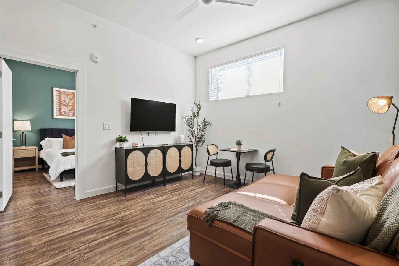 Bright and airy living room with plush seating, a large TV, and tasteful decor, creating the perfect space for relaxation and entertainment.