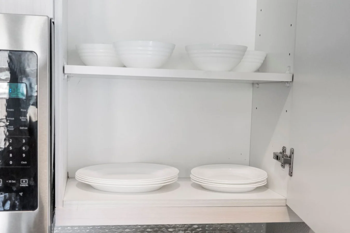 Kitchen cabinets stocked with cooking wares, glassware and silverwares, ideal for mixing up your favorite meals and drinks during your stay.