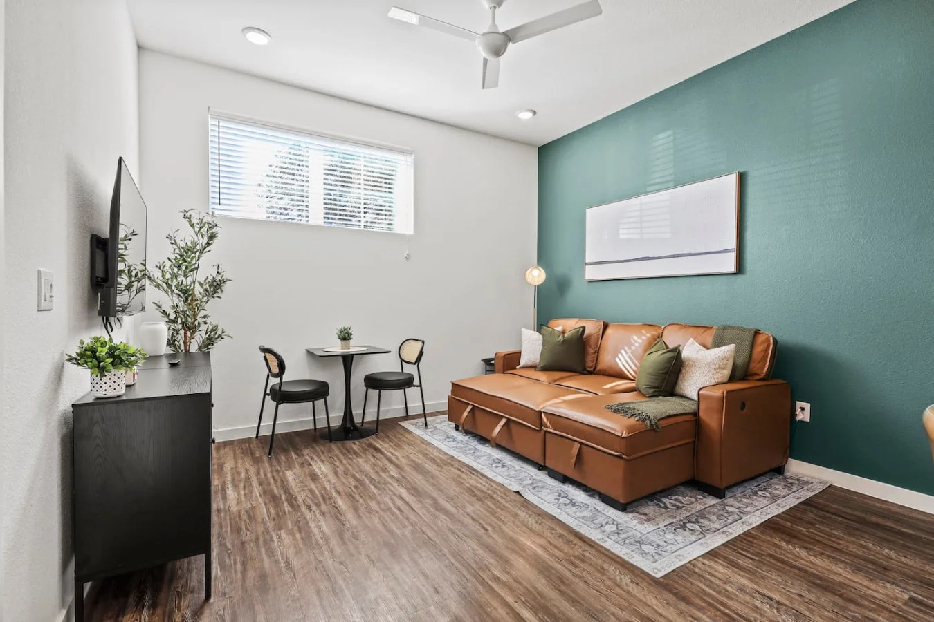 The living room is filled with natural light, creating a bright and welcoming space that invites relaxation.