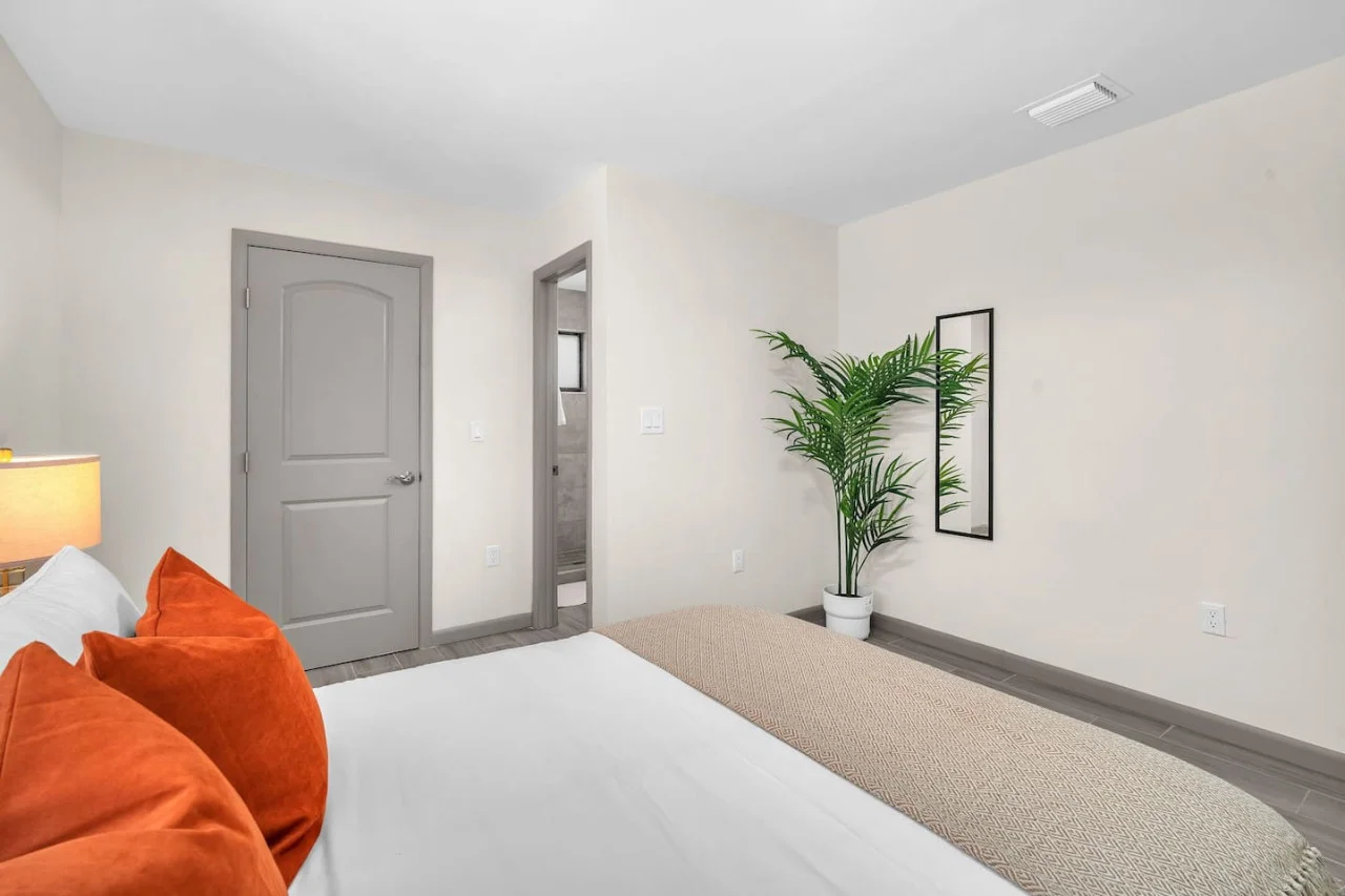 A view of the bedroom leading to the attached washroom.