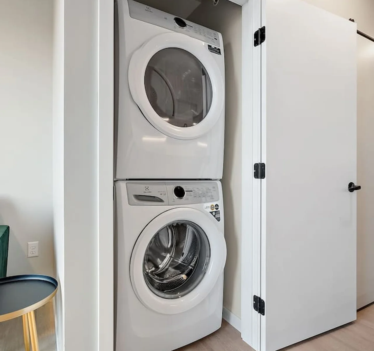 Laundry room with a washer, dryer, and folding area, offering all the convenience you need for a comfortable extended stay.