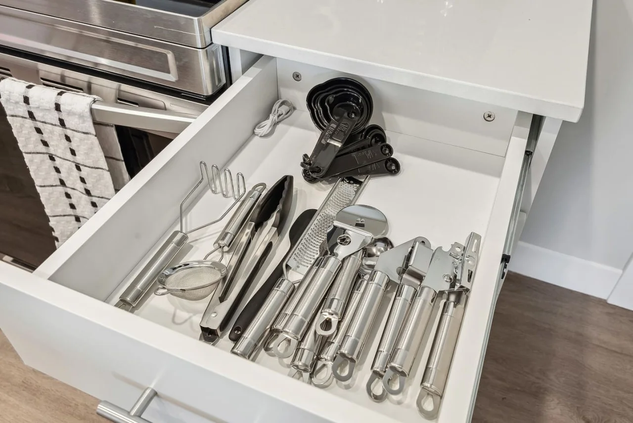 Kitchen utensils with scissors, measuring cups, grater, wine opener, can opener