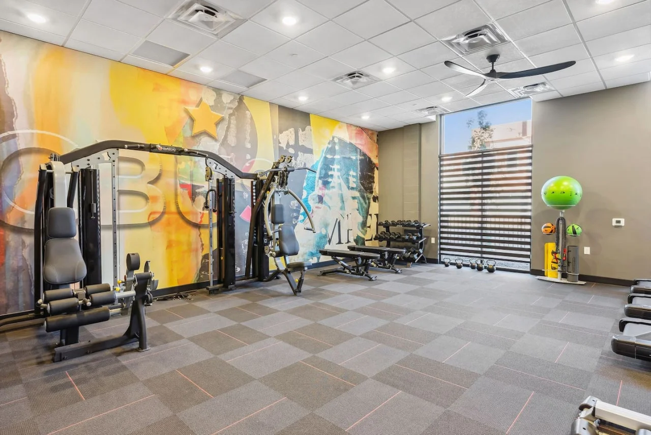 Open floor area with exercise mats, yoga balls, and foam rollers for warm-ups, stretching, or core exercises.