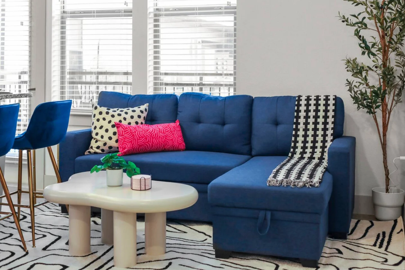 Bright and airy living room with plush seating, a large TV, and tasteful decor, creating the perfect space for relaxation and entertainment.