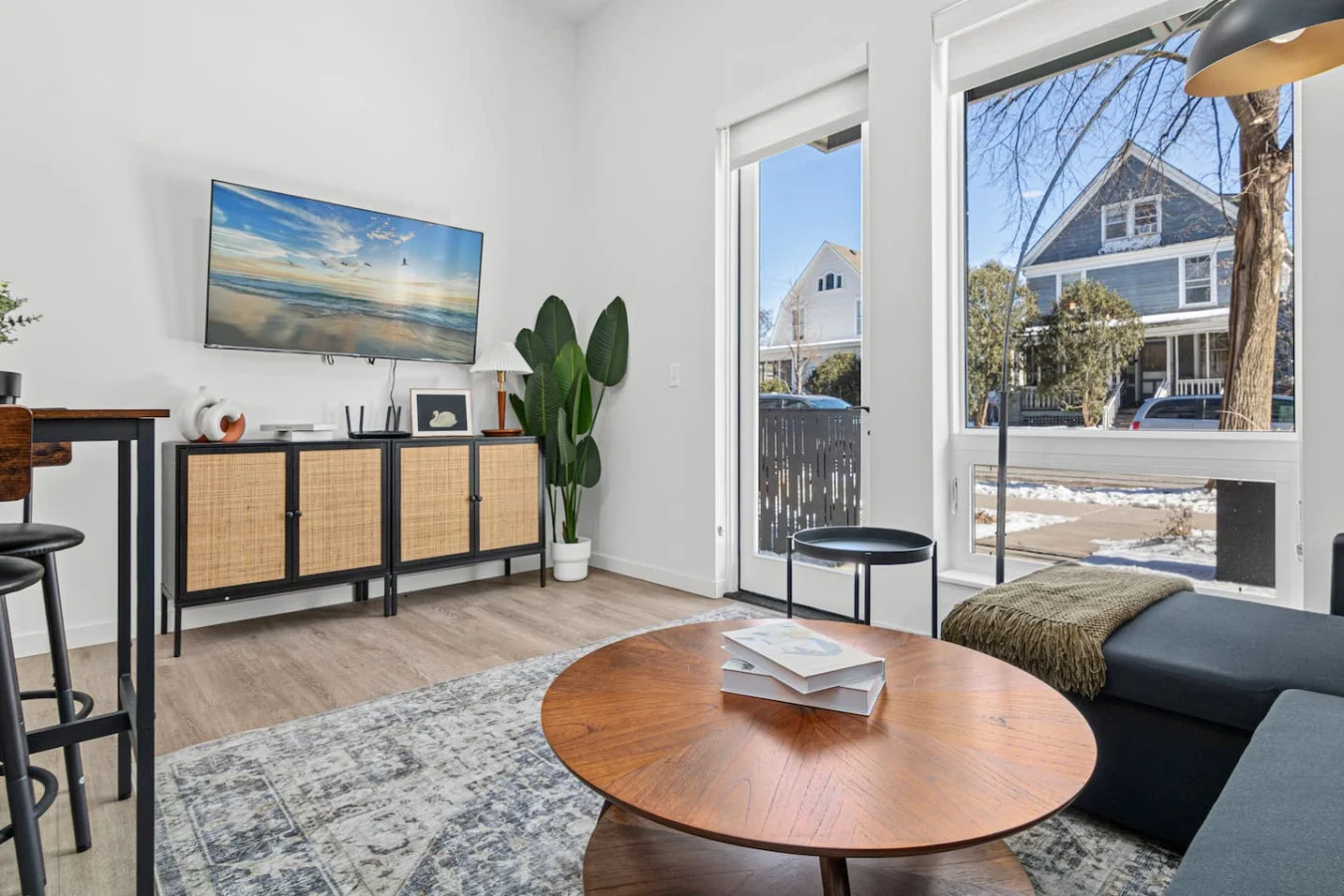The living room’s plush seating beckons you to sink in and relax, surrounded by light and airy decor.