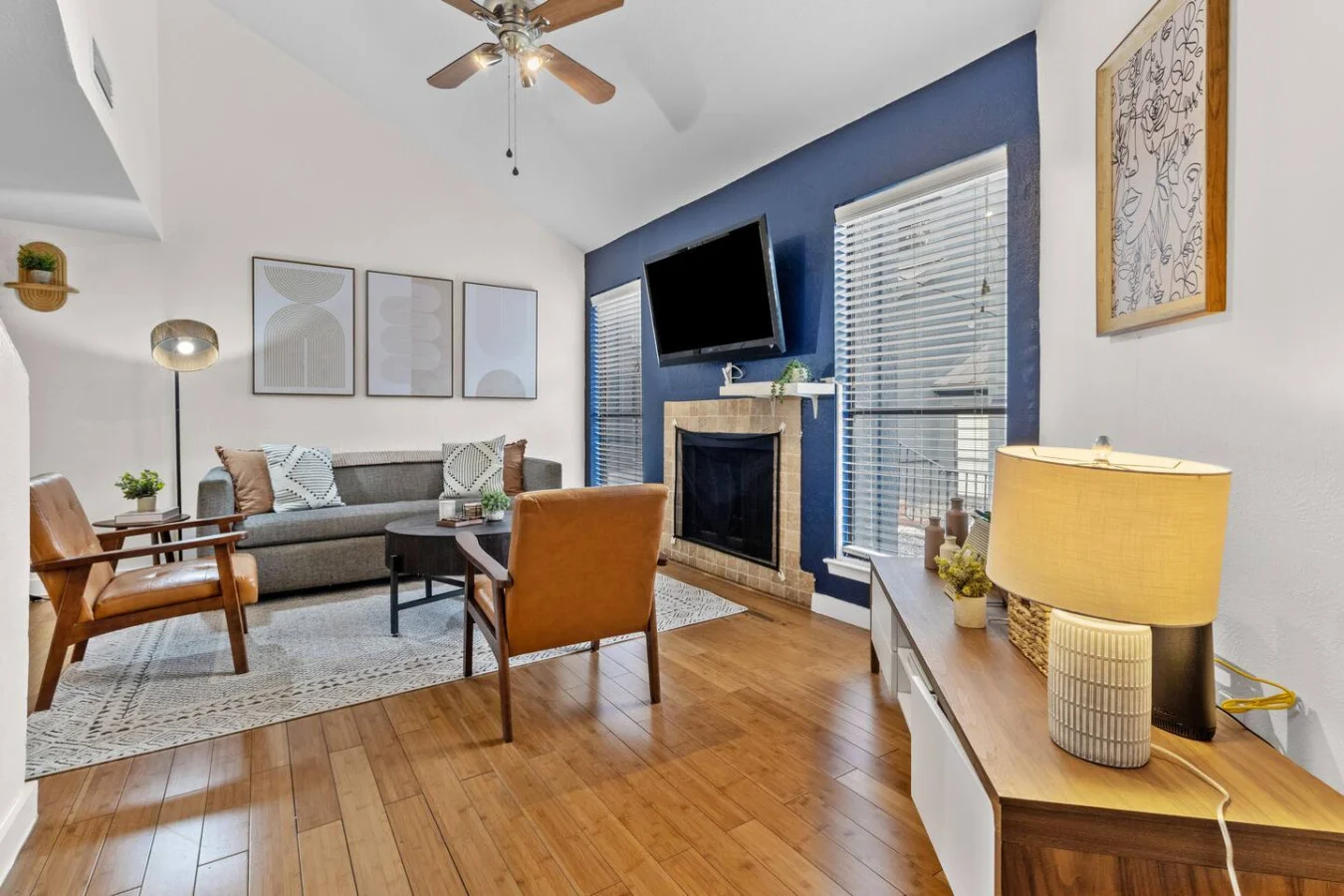 Spacious living room with hardwood floors and natural light