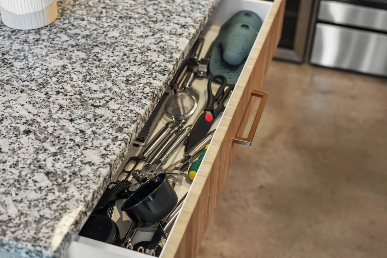Kitchen utensils with scissors, measuring cups, grater, wine opener, can opener