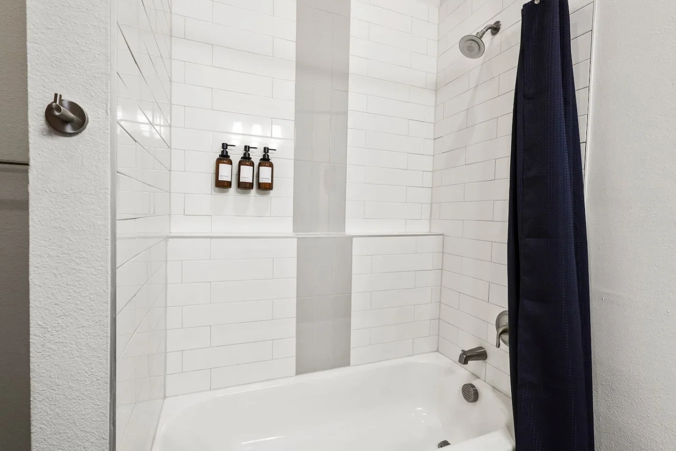 This bright and welcoming bathroom invites you to freshen up in comfort. Enjoy the forest-inspired shower curtain that adds a calming touch to your routine, complemented by the cozy rug underfoot and sparkling clean fixtures.