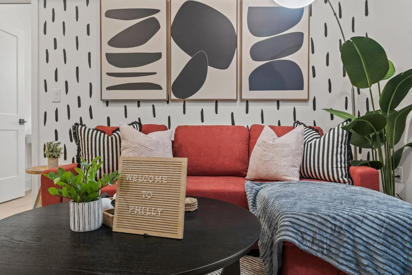 The living room’s plush seating beckons you to sink in and relax, surrounded by light and airy decor.