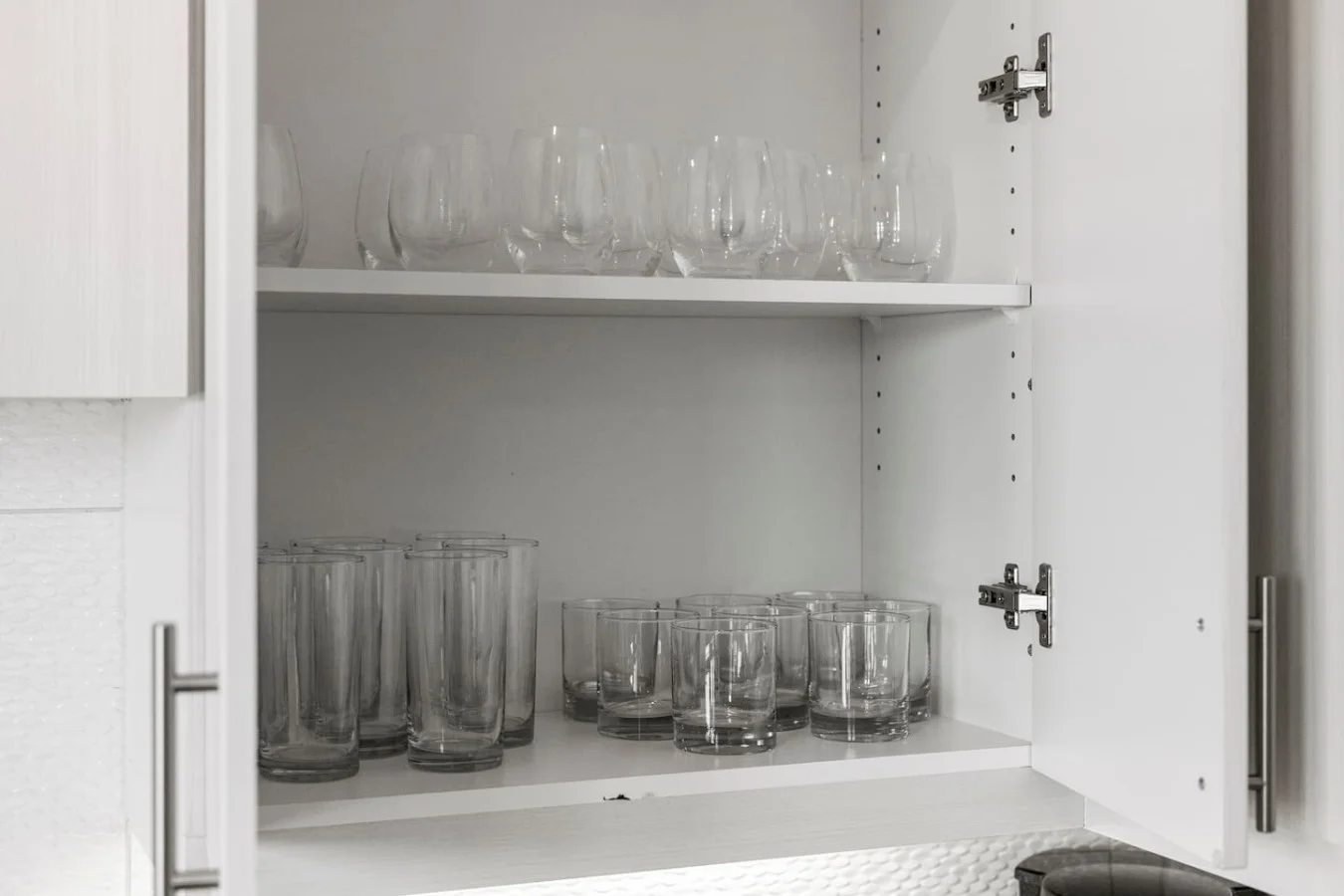 Kitchen cabinets stocked with cooking wares, glassware and silverwares, ideal for mixing up your favorite meals and drinks during your stay.