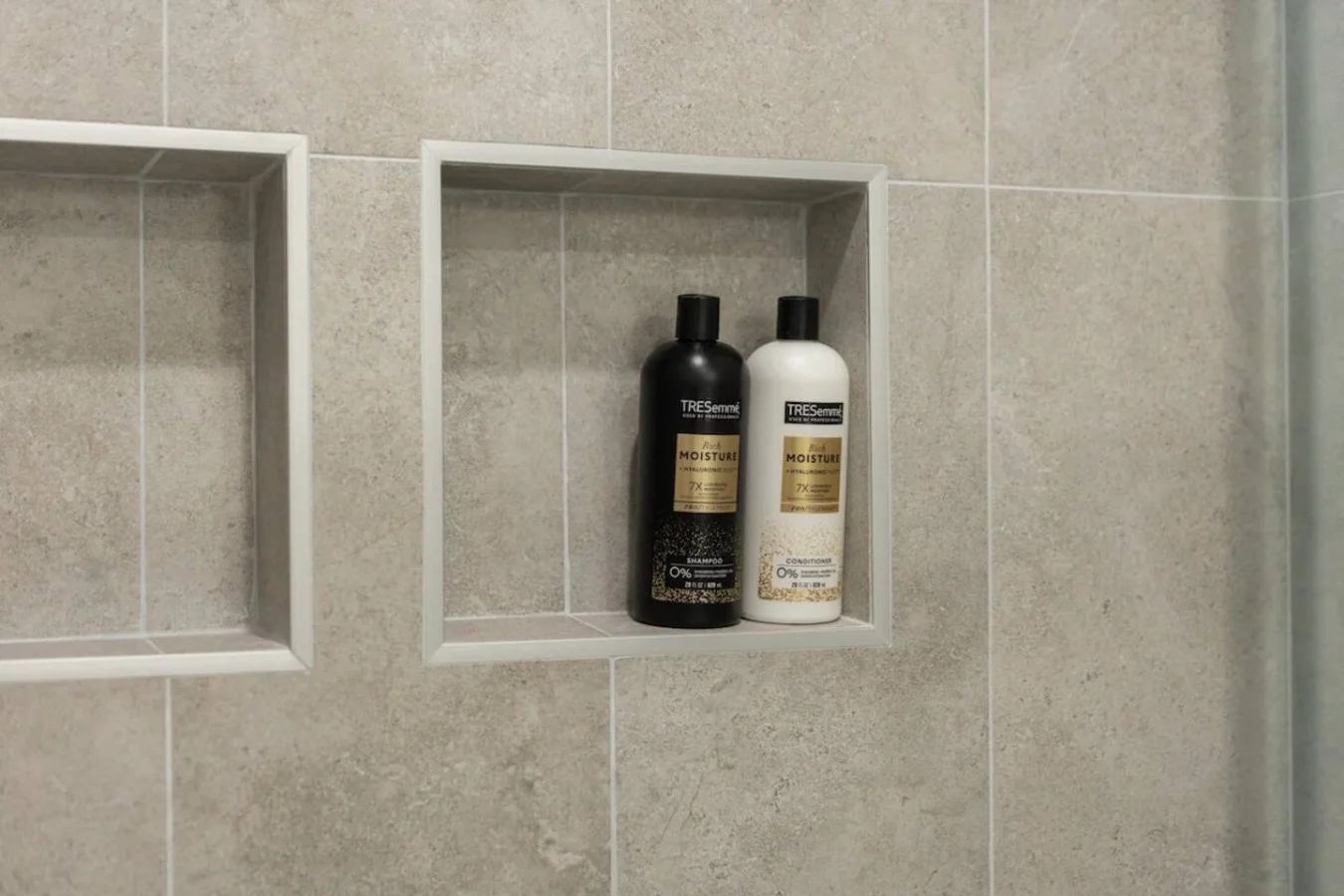 Immaculate bathroom featuring a spacious shower, fresh towels, and complimentary toiletries for a spa-like experience.