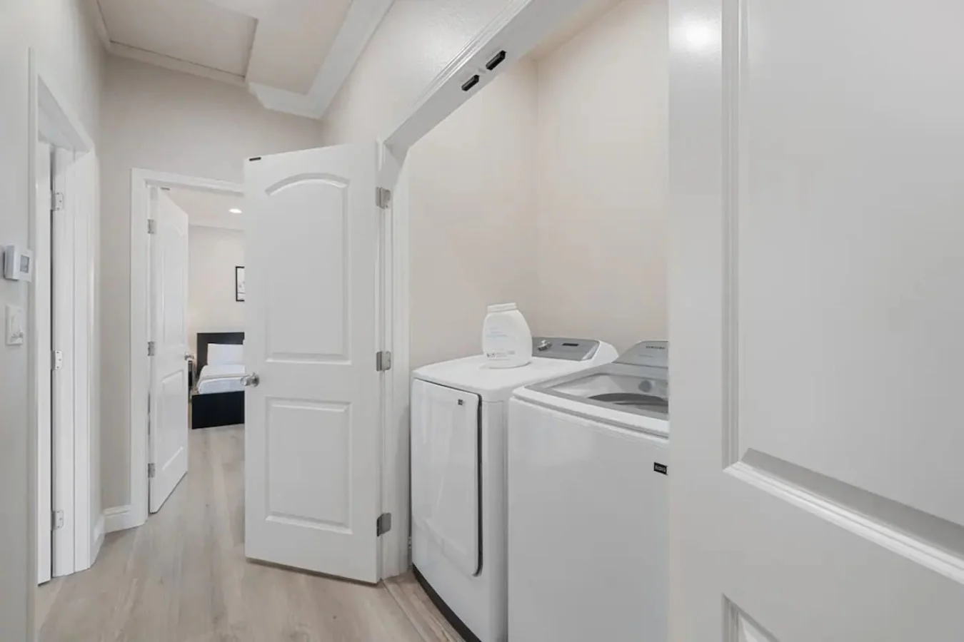 As you step into the laundry room, the modern appliances and ample storage space make it easy to keep things tidy.