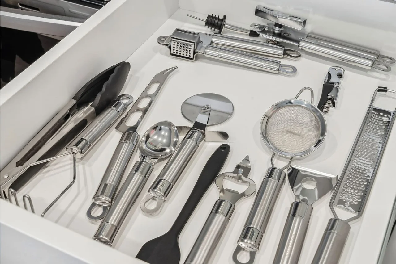 Kitchen utensils with scissors, measuring cups, grater, wine opener, can opener