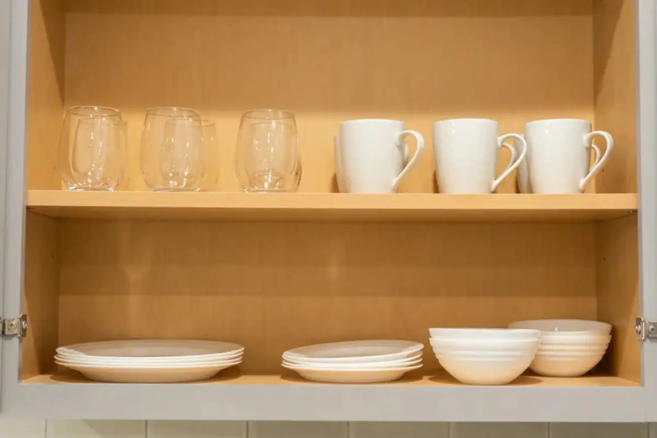 Kitchen cabinets stocked with cooking wares, glassware and silverwares, ideal for mixing up your favorite meals and drinks during your stay.