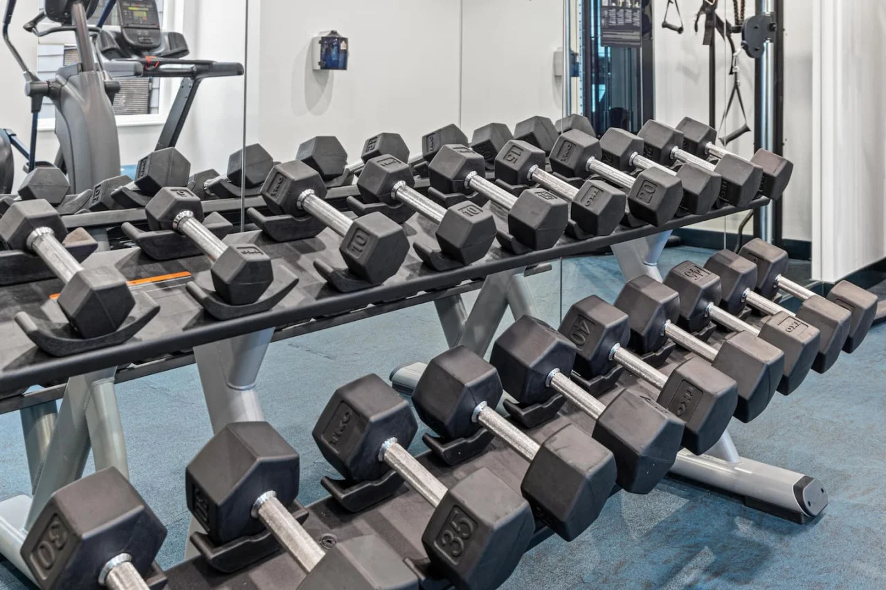 Dedicated space featuring a wide range of dumbbells, benches, and mirrors for strength and resistance training