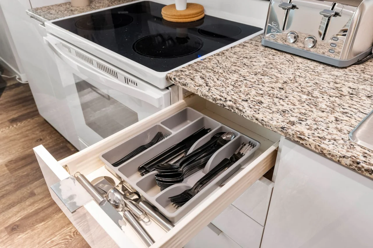 Kitchen cabinets stocked with cooking wares, glassware and silverwares, ideal for mixing up your favorite meals and drinks during your stay.