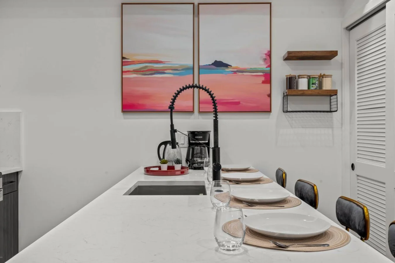 Cozy dining area with beautiful paintings as backdrop.