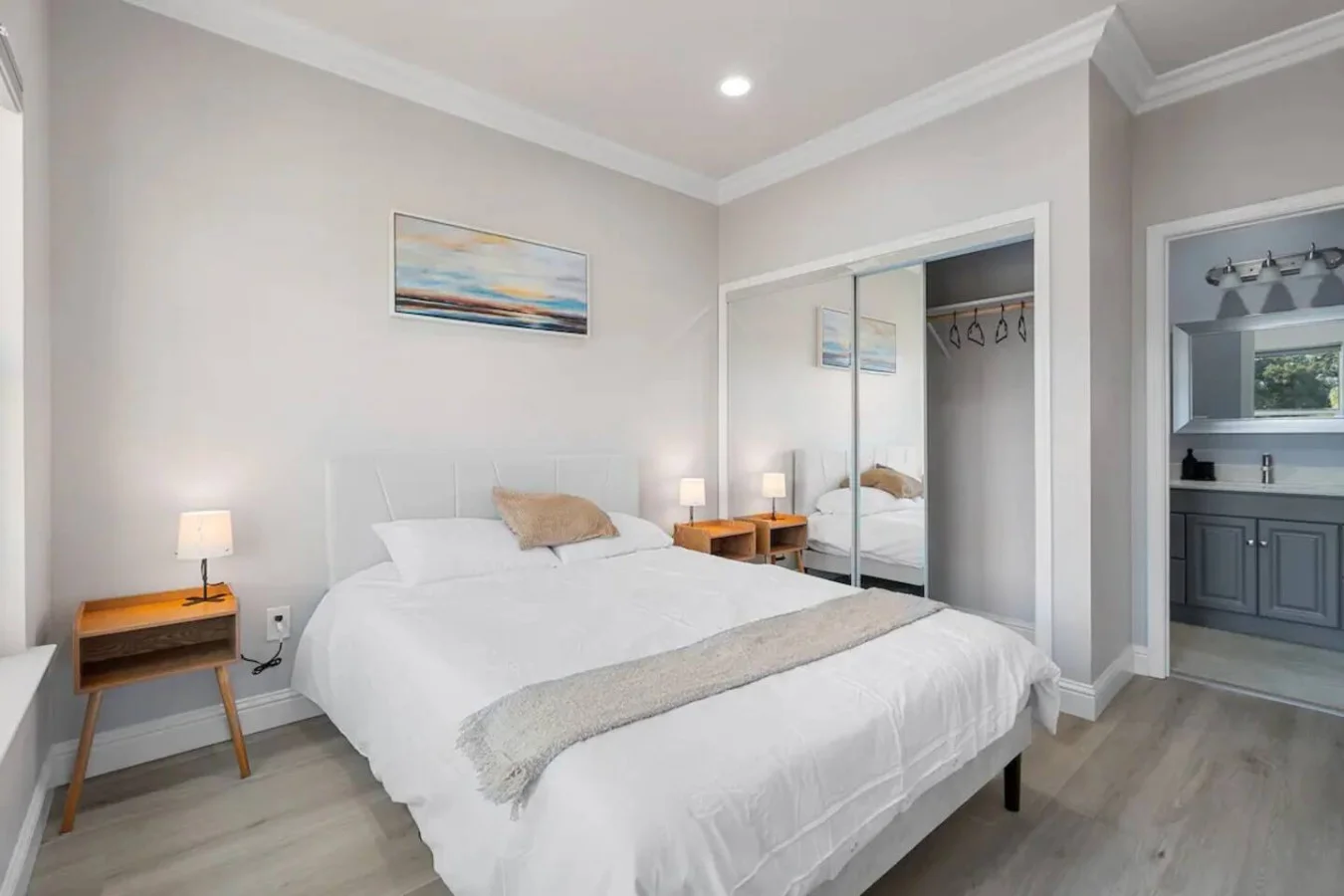 You feel enveloped in comfort as you relax on the queen bed, surrounded by a room designed for tranquility.