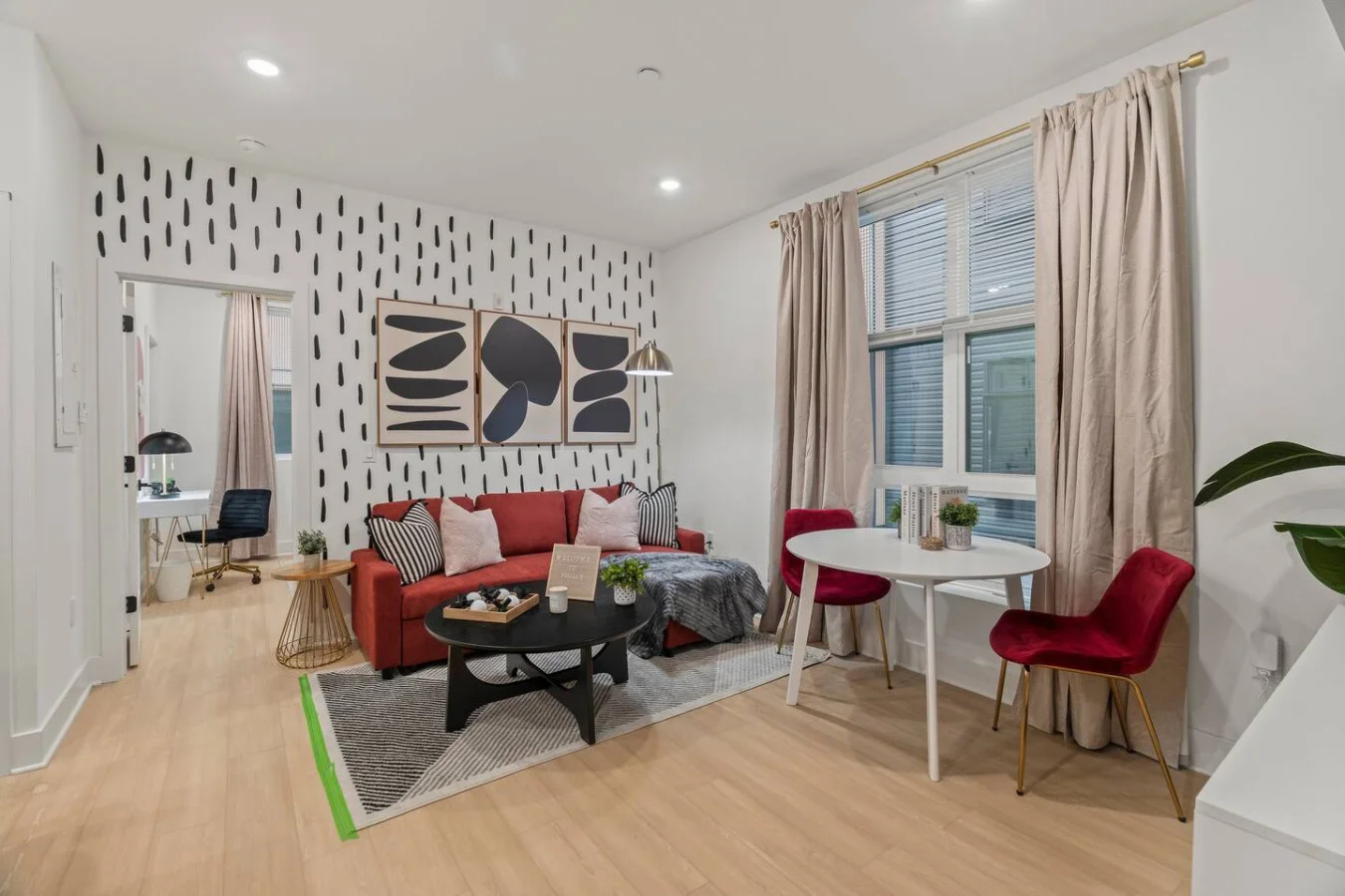 The living room’s plush seating beckons you to sink in and relax, surrounded by light and airy decor.