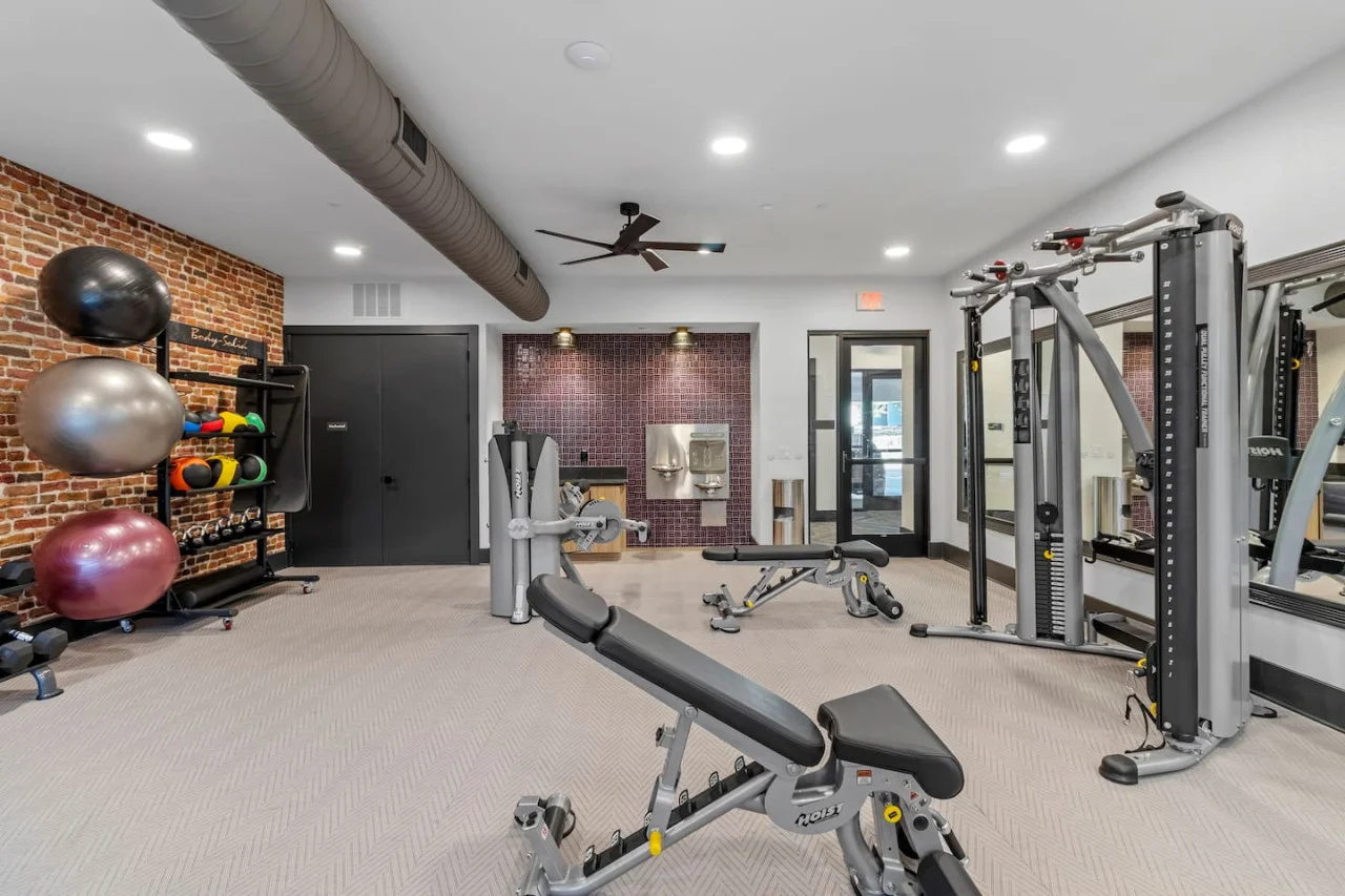 Open floor area with exercise mats, yoga balls, and foam rollers for warm-ups, stretching, or core exercises.