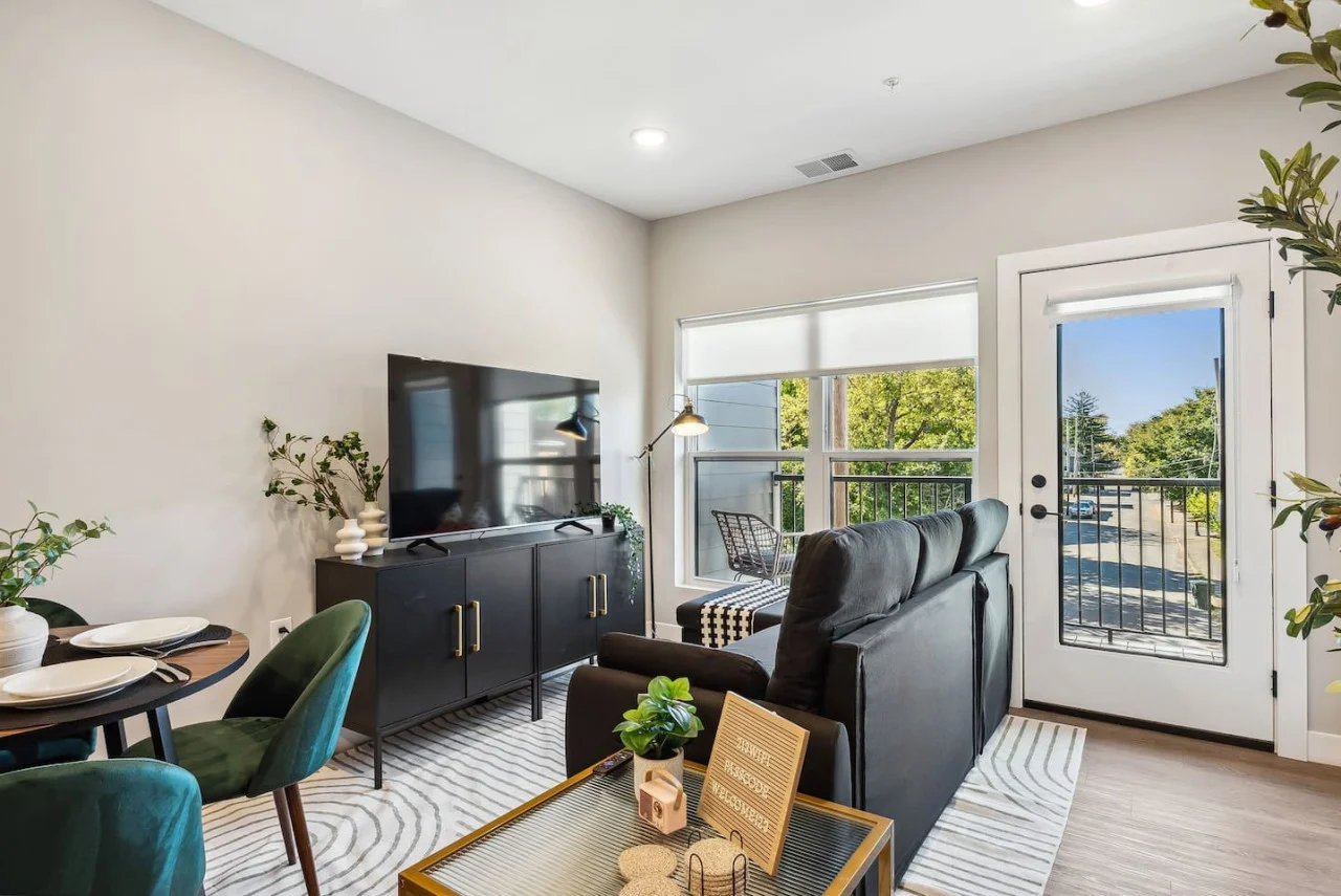 Bright and airy living room with plush seating, a large TV, and tasteful decor, creating the perfect space for relaxation and entertainment.