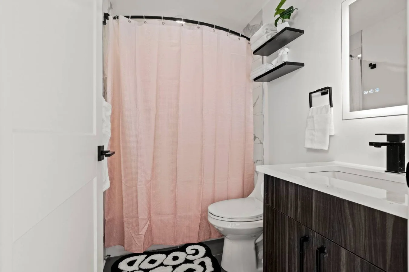 Modern bathroom with shower curtains and essentials provided (high quality linens, hairdryer, toilet paper)