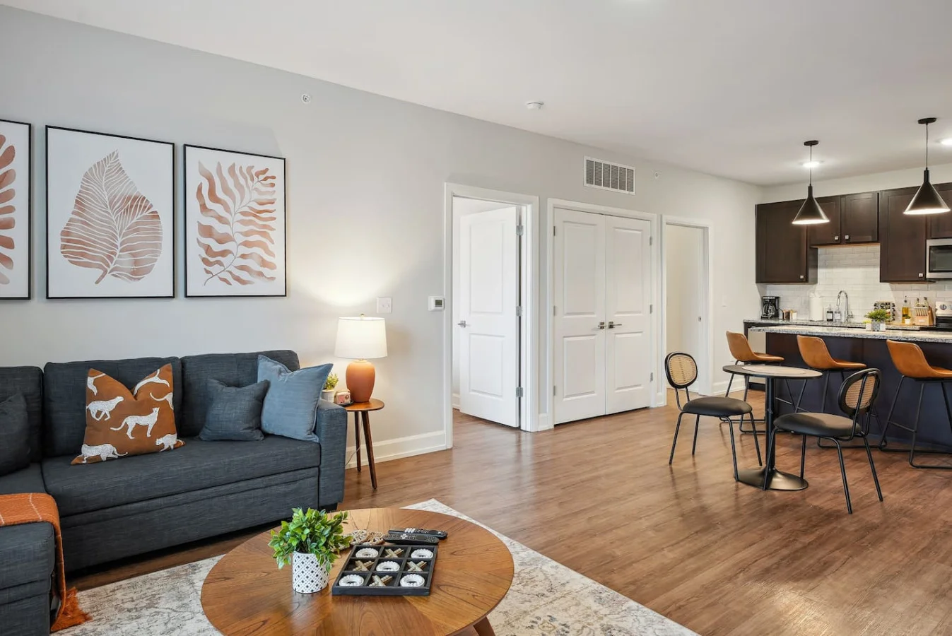 Spacious open-concept living and dining area featuring a vibrant sofa, modern furnishings, and a stylish entertainment setup—ideal for gatherings and relaxation.