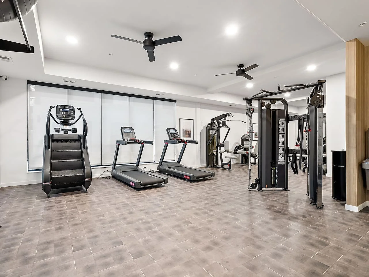 Open floor area with exercise mats, yoga balls, and foam rollers for warm-ups, stretching, or core exercises.