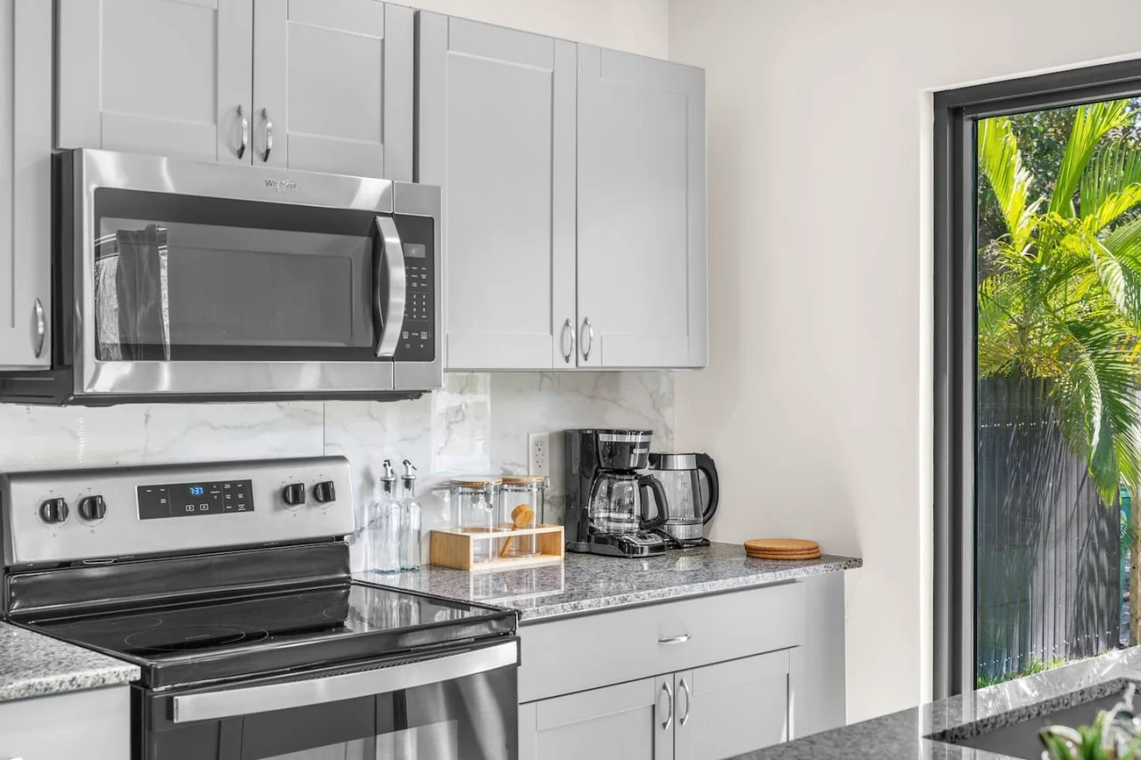 Elegant kitchen corner with stainless steel finishes, a coffee station.