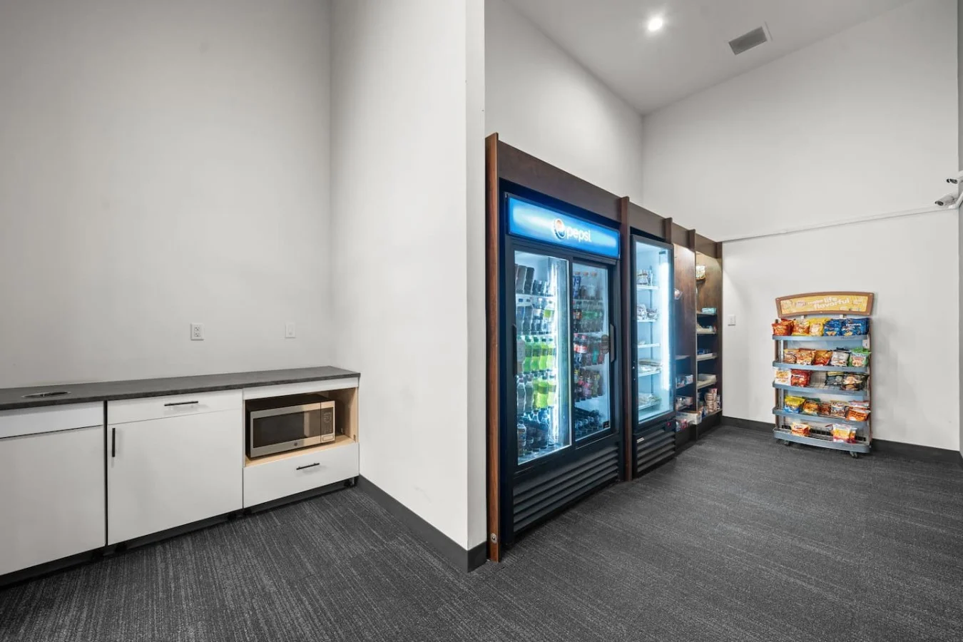 Convenient micro market with self-checkout stocked with food, snacks, drinks, and everyday items