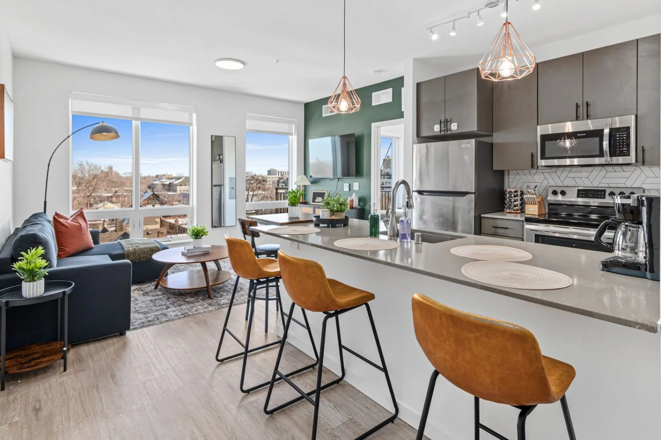 Spacious open-concept living and dining area featuring a vibrant sofa, modern furnishings, and a stylish entertainment setup—ideal for gatherings and relaxation.