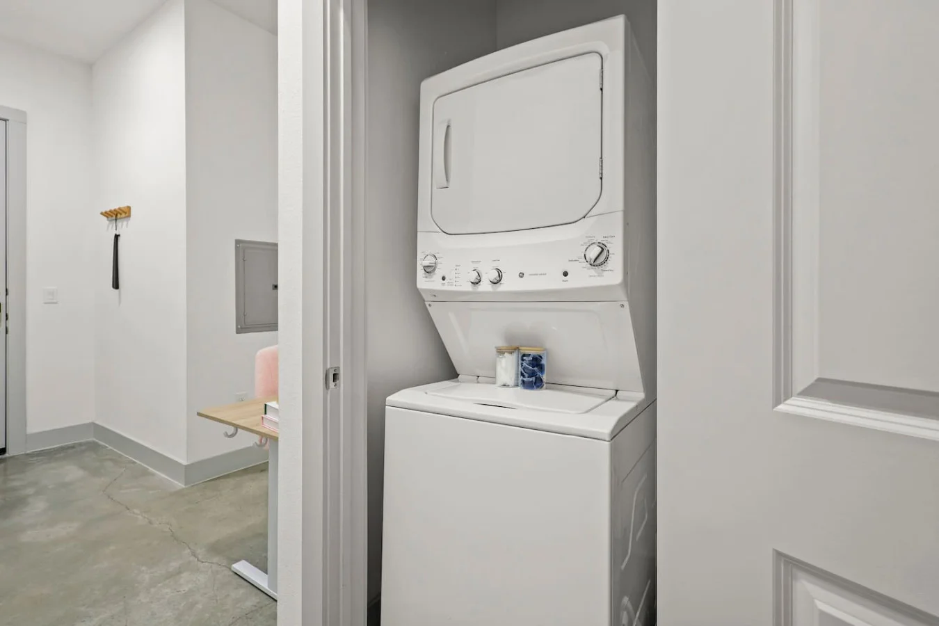 As you step into the laundry room, the modern appliances and ample storage space make it easy to keep things tidy.