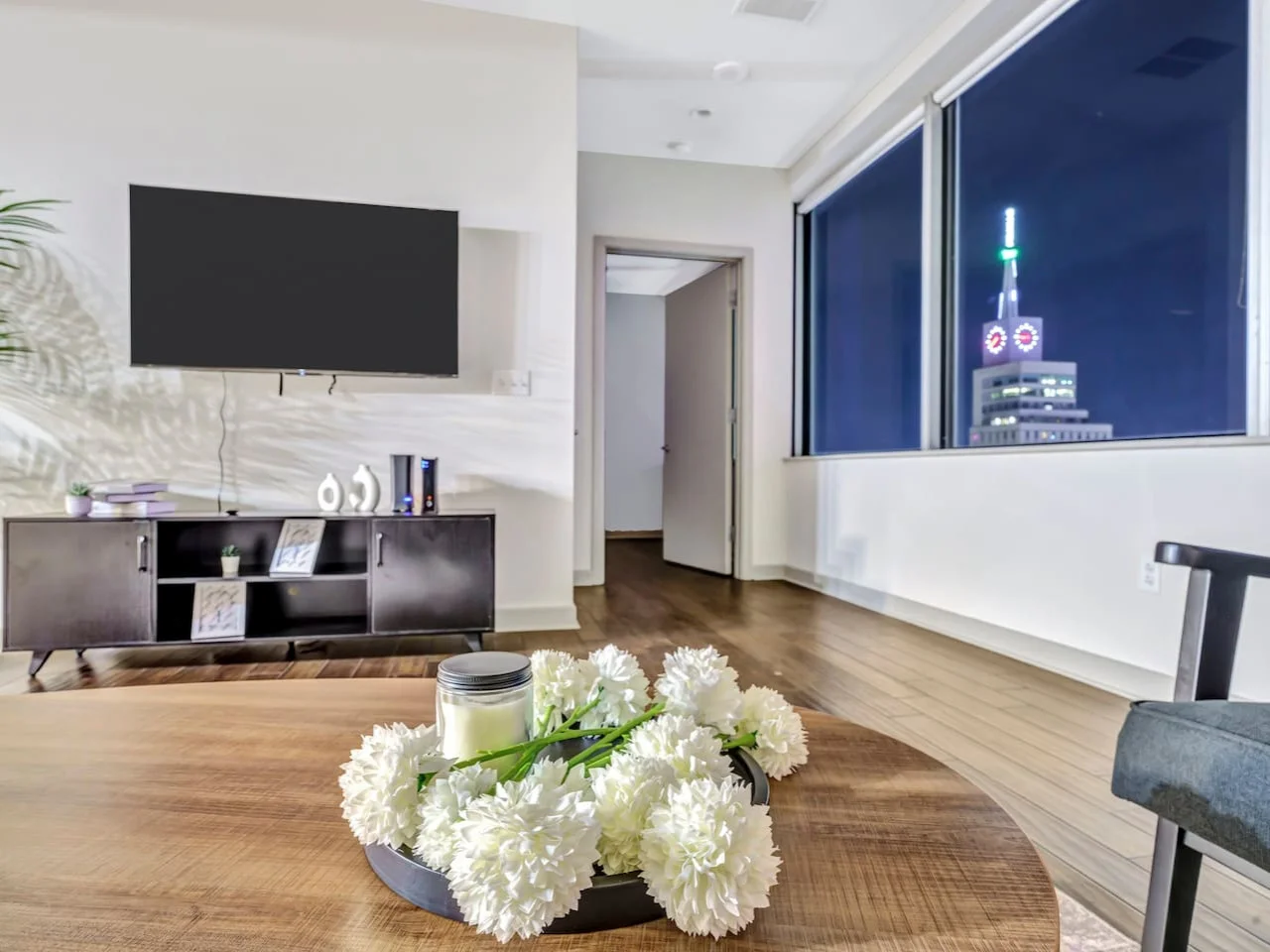 Bright and airy living room with plush seating, a large TV, and tasteful decor, creating the perfect space for relaxation and entertainment.