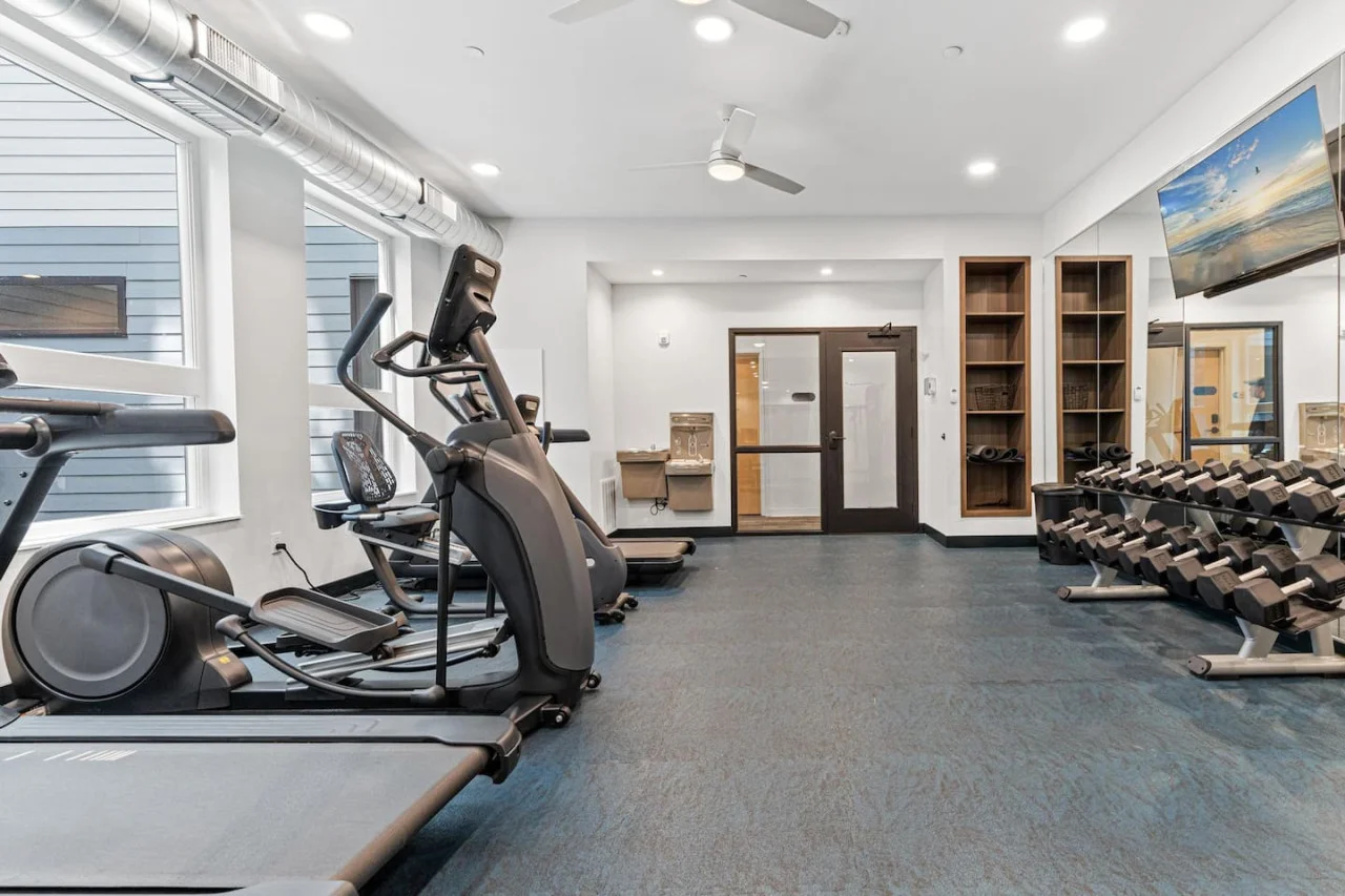 Open floor area with exercise mats, yoga balls, and foam rollers for warm-ups, stretching, or core exercises.