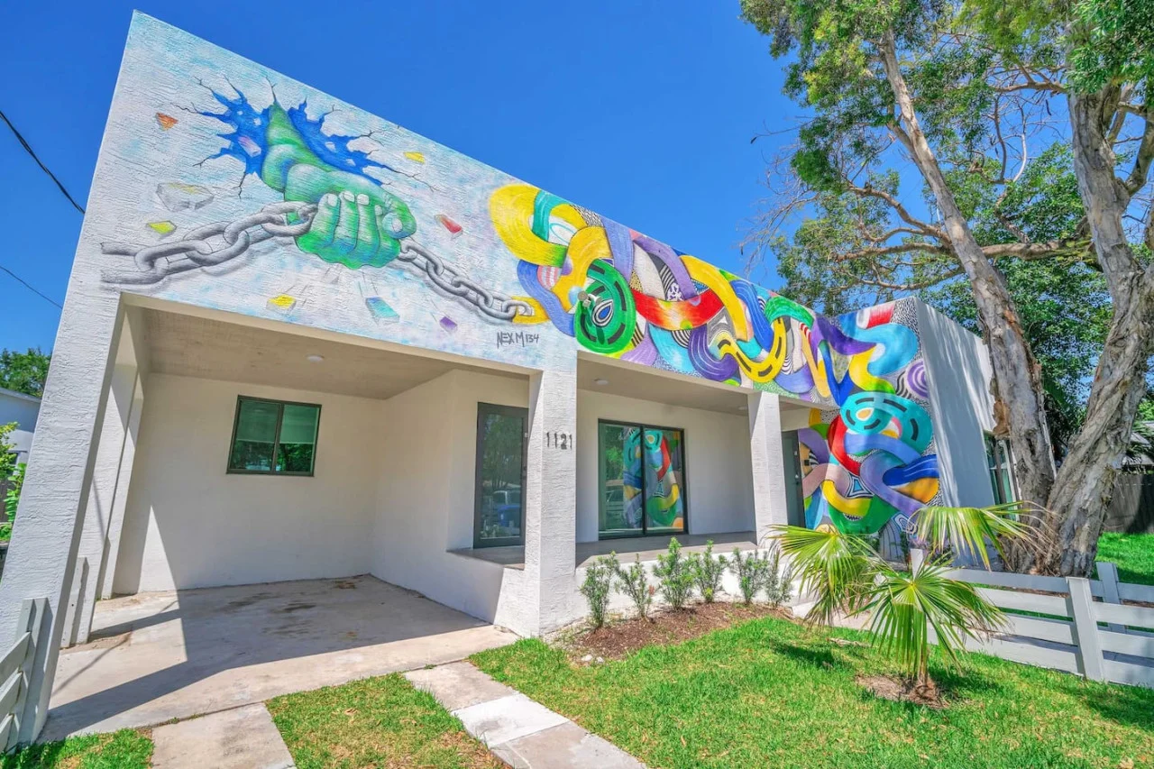 The artistic building facade showcases bold, colorful designs that complement the clean, modern architecture.