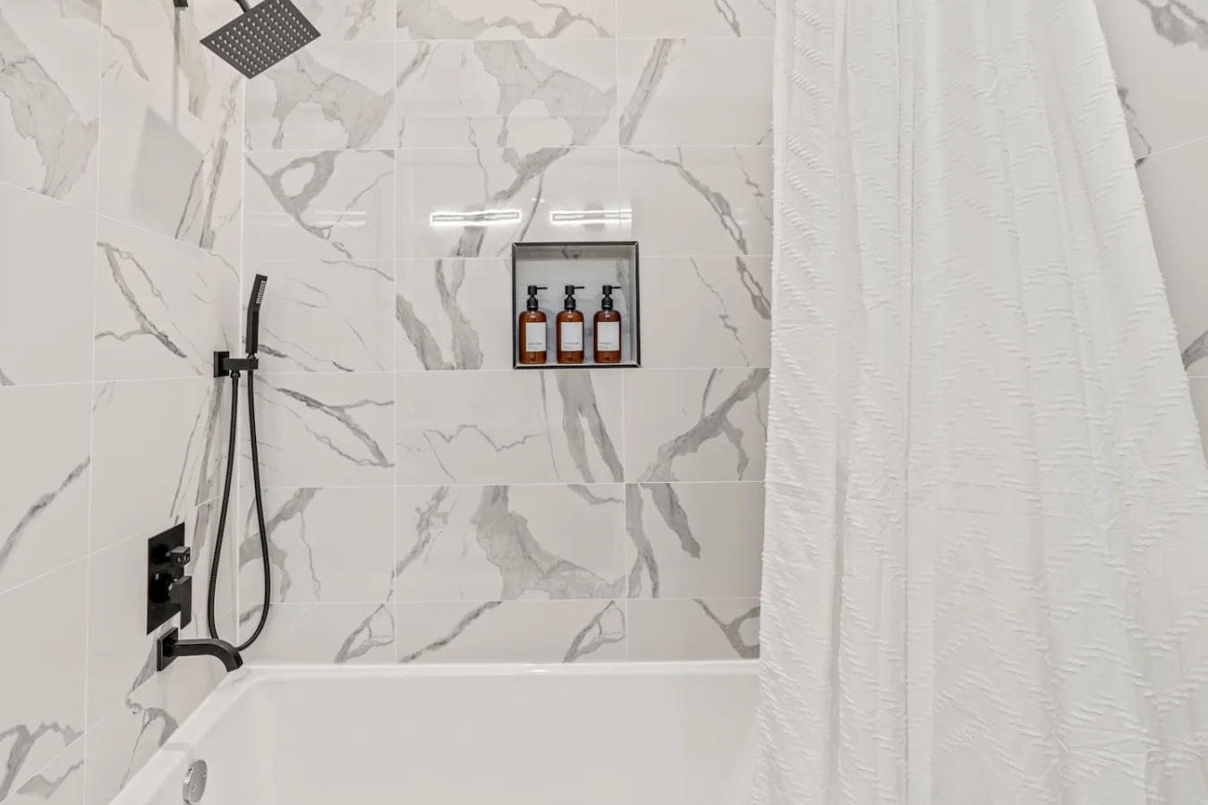 You feel a sense of calm as you enter the bathroom, where the thoughtful design and high-quality materials create a serene environment.