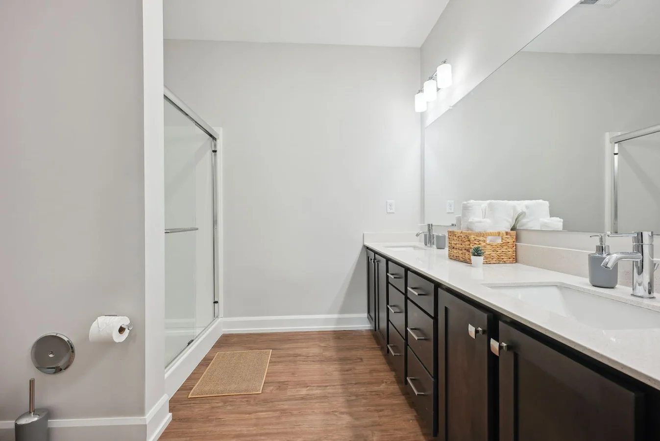 The bathroom is designed for comfort, with a spacious shower and elegant fixtures that make every moment feel luxurious.