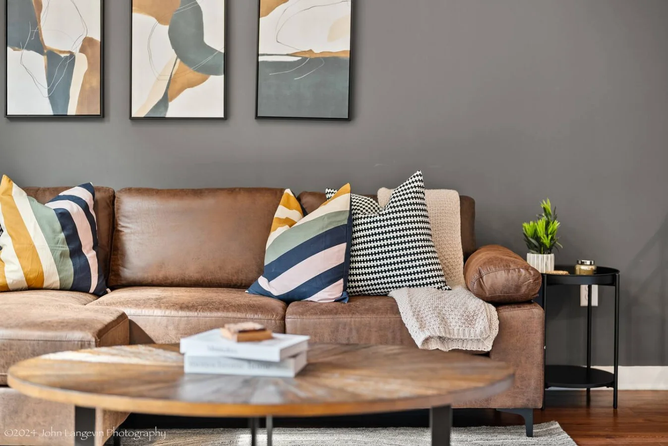 The living room’s plush seating beckons you to sink in and relax, surrounded by light and airy decor.